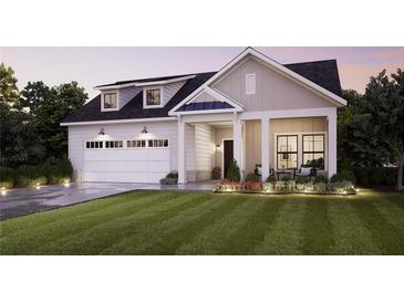 Modern farmhouse exterior with white garage door and landscaping at 5215 Maggie Mae Ln, Cumming, GA 30028