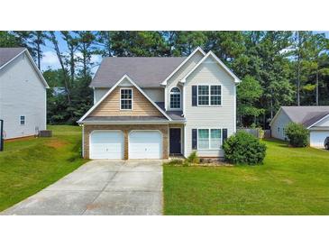 Two-story house with a double garage and a well-maintained lawn at 388 Oakhaven Way, Villa Rica, GA 30180