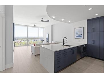 Modern kitchen with white quartz island and dark blue cabinetry at 3325 Piedmont Rd # 2203, Atlanta, GA 30305