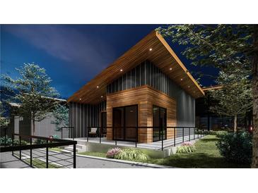 Modern home exterior with wood and metal siding at night at 6305 Shannon Parkway # 206, Union City, GA 30291