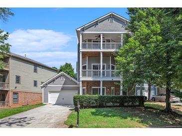 Two-story house with gray siding, large windows, and a two-car garage at 131 Bowen Sw Cir, Atlanta, GA 30315