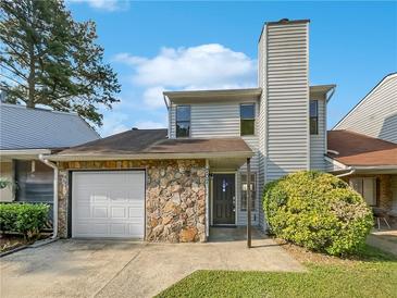 Two-story house with stone accents and a single-car garage at 707 Pine Tree Trl # 10B, Atlanta, GA 30349