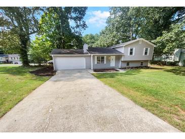 Ranch style home with attached garage and landscaping at 5351 Zachary Dr, Stone Mountain, GA 30083