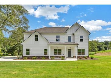 Two-story farmhouse with white siding and a welcoming front porch at , Covington, GA 30014