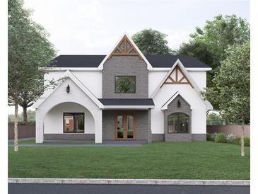 Two-story home features a stone and white exterior, a gabled roof, and landscaping at 474 Eastland Dr, Decatur, GA 30030