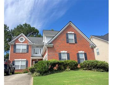 Brick house with a large front yard and a driveway at 492 Mimosa Grove Xing, Tucker, GA 30084
