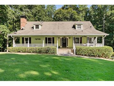 Charming ranch home with a covered porch and well-manicured lawn at 4396 Highway 166, Douglasville, GA 30135