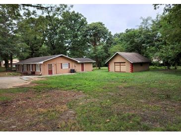 Property with house, detached garage, and large yard at 3061 Sandy Plains Rd, Marietta, GA 30066