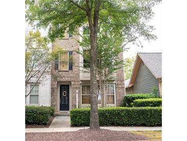 Brick front of townhome with landscaping at 9931 Mancunian Way, Douglasville, GA 30135