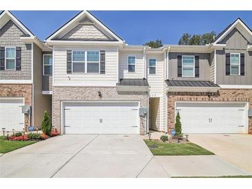 Two-story townhome with attached garage and landscaping at 174 Hampton Cir, Mcdonough, GA 30253