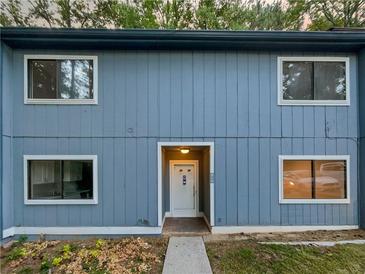 Charming blue two-story townhouse with a well-maintained front yard at 913 Pine Oak Trl, Austell, GA 30168