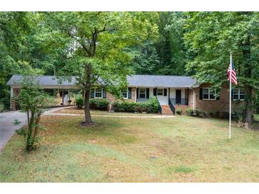 Brick ranch house with carport and lawn at 4480 Gann Xing, Smyrna, GA 30082