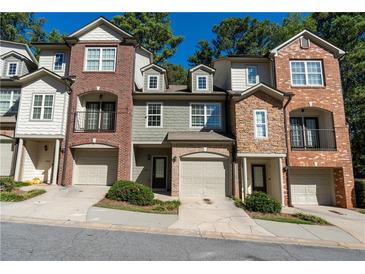 Three townhouses with brick and stone exterior at 2986 Ashlyn Pointe Dr, Atlanta, GA 30340