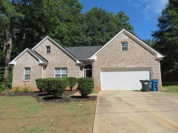 Brick ranch home with a two-car garage and landscaping at 3475 Washington Rd, Atlanta, GA 30344