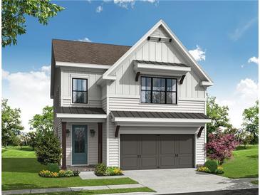 Two-story farmhouse style home with gray garage doors and white siding at 615 Skytop Dr, Cumming, GA 30040