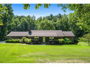 Ranch style home with large yard and mature trees at 725 Holland Rd, Powder Springs, GA 30127