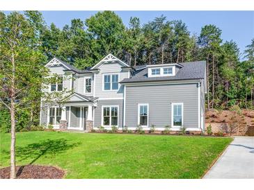 Two story gray house with white accents and green lawn at 200 Etris Grove Ct, Roswell, GA 30075