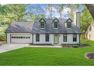 Charming one-story house with a gray roof, white siding, and green door at 1161 Appian Way, Lawrenceville, GA 30046