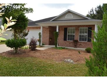 Brick ranch house with a covered porch and well-manicured landscaping at 1007 Sycamore Ln, Villa Rica, GA 30180