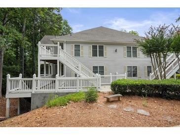 Two-story condo building with private deck and landscaping at 608 Abingdon Way, Atlanta, GA 30328