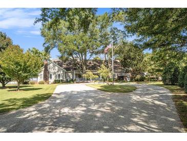 Ranch style home with a long driveway and mature trees at 1170 Lowell Rd, Carrollton, GA 30116