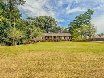Charming ranch home with large yard and mature trees at 1152 Harbins Rd, Dacula, GA 30019