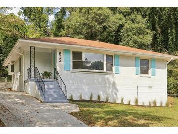 Ranch home with light brick exterior and blue shutters at 822 Gertrude Nw Pl, Atlanta, GA 30318