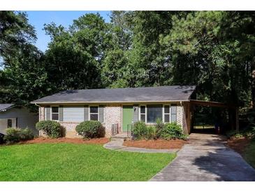 Brick ranch house with a green door and carport at 3523 Se Garfield Se Way, Atlanta, GA 30354