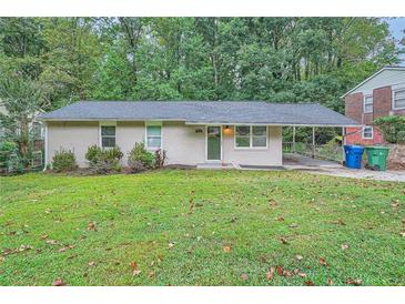 Charming ranch home with carport and lawn at 700 Symphony Nw Ln, Atlanta, GA 30318