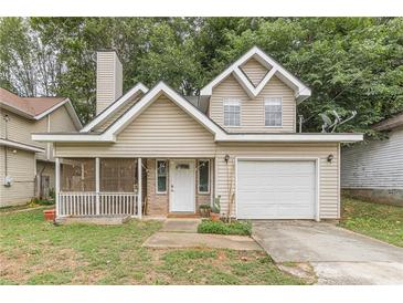 Tan two-story house with attached garage and porch at 217 Maple Nw St, Atlanta, GA 30314