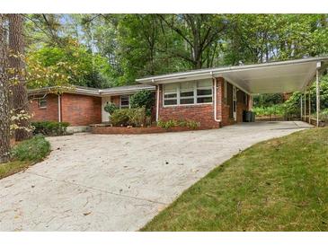 Brick ranch house with carport and landscaping at 2478 Woodacres Ne Rd, Atlanta, GA 30345