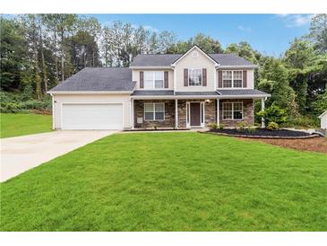 Two-story house with stone accents, attached garage, and landscaped yard at 2989 Wynhaven Oaks Way, Lawrenceville, GA 30043