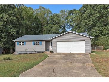 One-story house with gray siding, white garage door, and blue shutters at 315 Watts Rd, Hiram, GA 30141