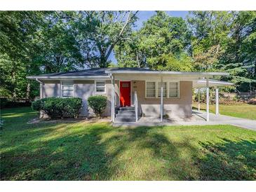 Brick ranch house with red door and carport at 1371 Varner Rd, Marietta, GA 30062