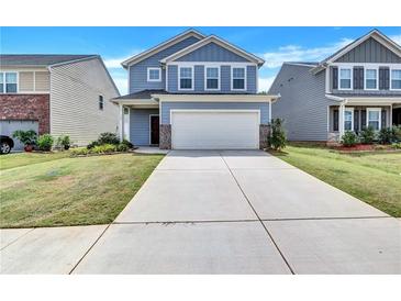 Two-story home with gray siding, brick accents, and a two-car garage at 116 Paulownia Cir, Mcdonough, GA 30253