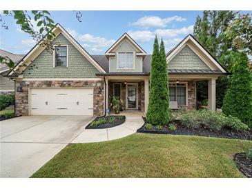 Attractive two-story home with stone and siding accents, two-car garage, and manicured lawn at 3124 Bentgrass Ln, Kennesaw, GA 30144