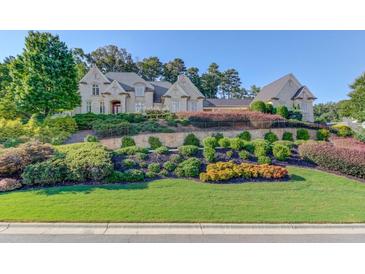 Stunning two-story home with stone exterior and manicured landscaping at 5004 Gunnison Trce, Suwanee, GA 30024