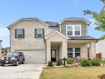 Two story home with brick facade and two-car garage at 719 Sara Meadow Rd, Loganville, GA 30052