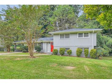 Gray house with red door, landscaping, and driveway at 3189 Dogwood Dr, Atlanta, GA 30344