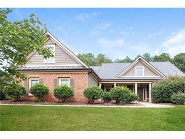 Two story house with gray siding and brick accents at 1209 Richmond Rdg, Loganville, GA 30052