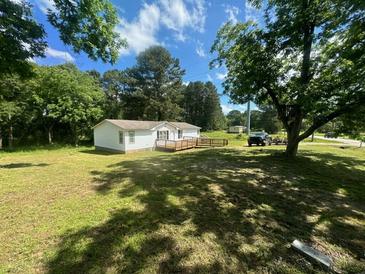 Single wide mobile home with deck and yard at 3600 Grady Smith Rd, Loganville, GA 30052