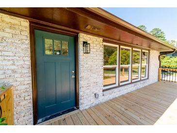 Inviting front door with teal green paint and wood deck at 3152 Spreading Oak Sw Dr, Atlanta, GA 30311