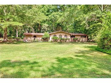 Ranch house on a large lot with mature trees at 5005 Jones Rd, Fairburn, GA 30213