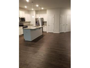 Modern kitchen with white cabinets and island at 7298 Rockhouse Rd # 5, Austell, GA 30168