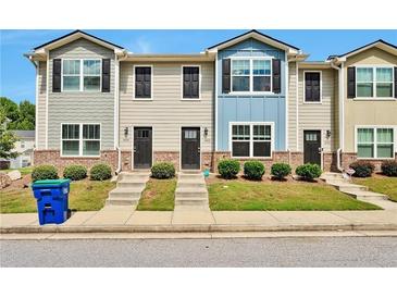 Three-unit townhouse building with gray and blue siding at 4433 Pinscher St, Union City, GA 30291