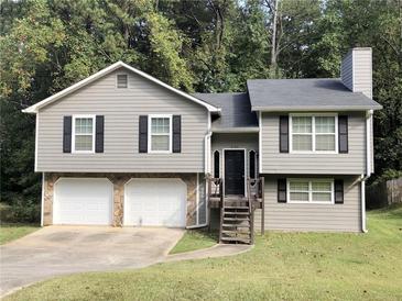 Two-story house featuring a gray exterior, double garage, and a landscaped yard at 6190 Tucker Ln, Union City, GA 30291