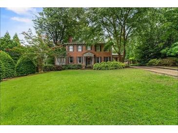 Brick home with lush green lawn and driveway at 1323 Briarcliff Ne Rd, Atlanta, GA 30306