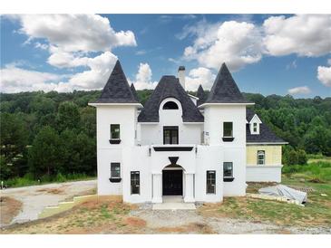 A unique castle-style home with a black roof at 1197 Dee Kennedy Rd, Auburn, GA 30011