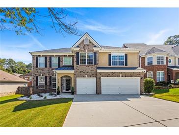 Brick two-story house with a two-car garage and landscaped front yard at 150 Klondike Sw St, Atlanta, GA 30331