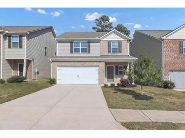 Two-story house with gray siding and a white garage door at 10922 Wheeler Trce, Hampton, GA 30228